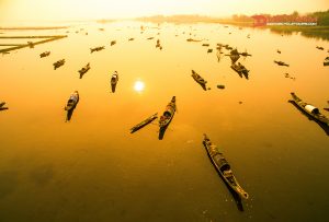 Boats in Tam Giang lagoon in sunrise from drone.Hue, Vietnam